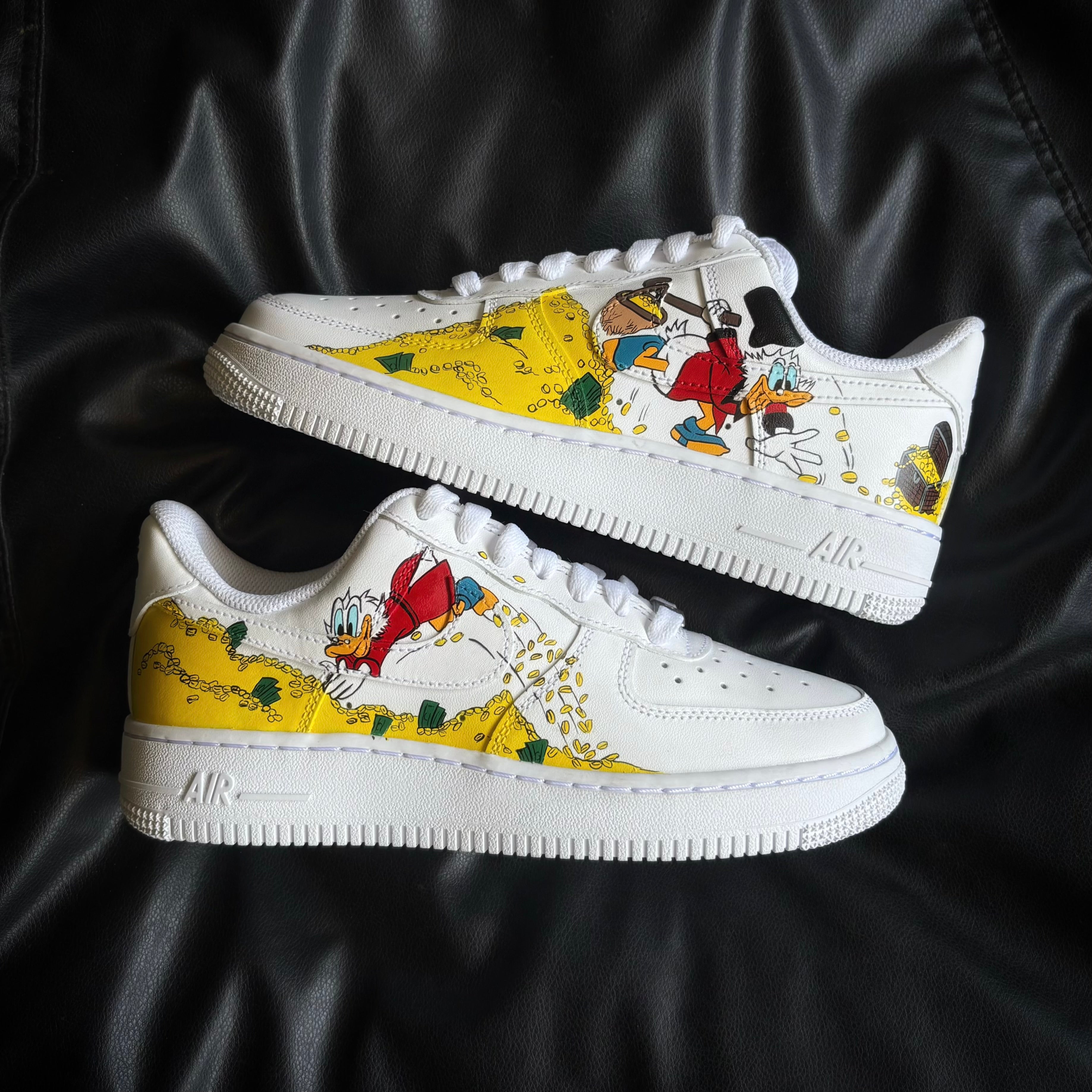 nike-air-force-1-x-scrooge-mcduck sneakers with cartoon character design on a black background